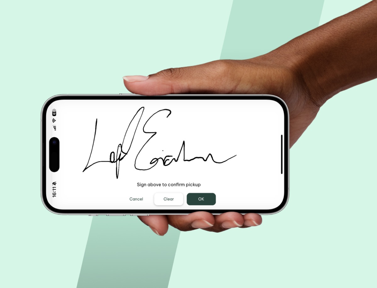 Hånd som holder iPhone med Gire-appens e-signaturskjerm, signer for å bekrefte henting